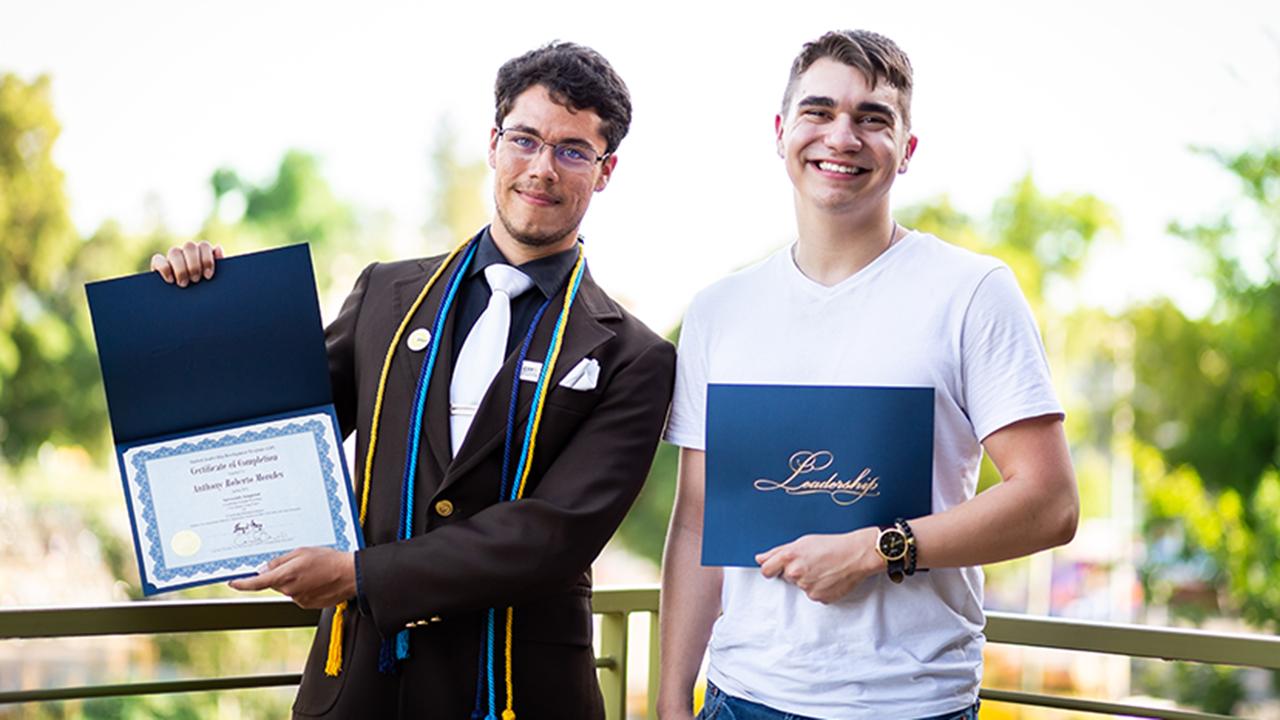 Brandon, pictured on right, receiving his SLDP certificate Brandon Certificate